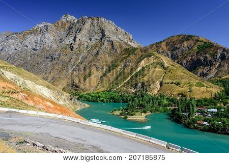 Panoramic view of Charvak Lake, a huge artificial lake-reservoir with azure water created by erecting a high stone dam on the Chirchiq River, located in Tashkent region of Uzbekistan