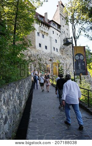 Bran Transylvania Romania - September 14 2017: medieval castle. Thanks to Bram Stoker's book the castle is considered the headquarters of the Dracula vampire. Tourists on the road leading to the castle.