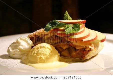 Traditional Apple Strudel With Mint Leaves And Sugar Powder.