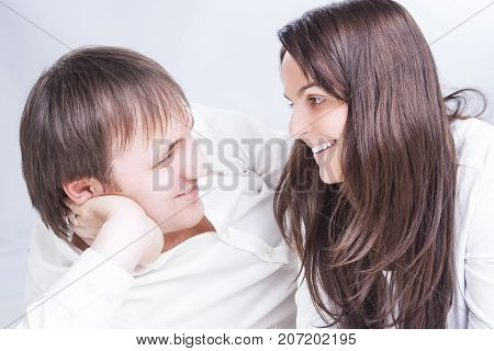 Family Relationships Concepts. Young Caucasian Family Communicating Together on Floor. Smiling and Embracing Each Other.Horizontal Image