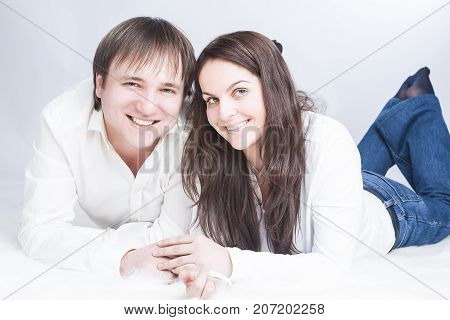 Family Ideas. Happy and Positive Caucasian Couple Having Time Together. communicating on Floor with Each Other While Looking Eyes To Eyes and Holding Hands In Touch. Horizontal Image Composition