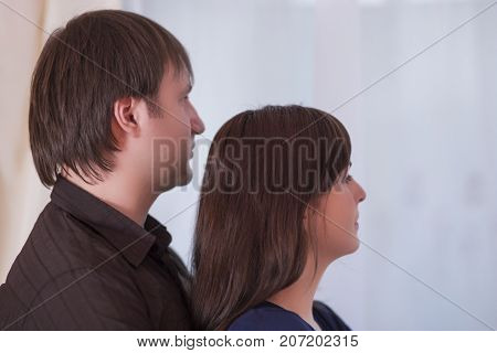 Family Ideas. Young Caucasian Couple Standing Together Embraced. Looking The same Side.Horizontal Image