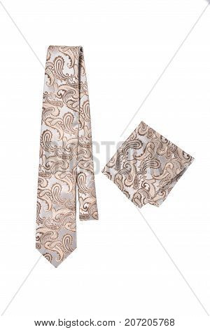 Beige paisley pattern tie and hanky on a white background