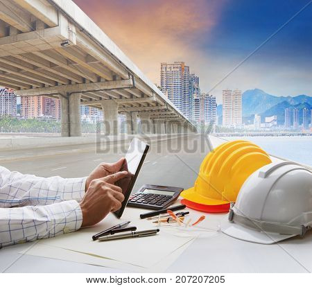 civil engineer working table and urban building with infra structure development