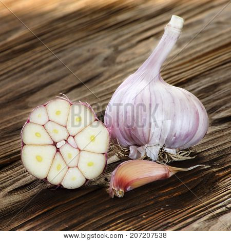 garlic closeup on a brown wooden kitchen table