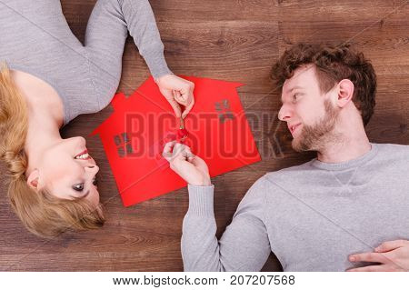 Young Couple Exchanging Keys.