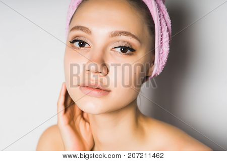 cute smiling girl after a shower looks directly at the camera
