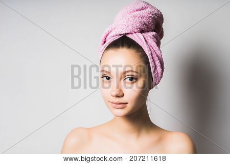 cute smiling girl after a shower looks directly at the camera