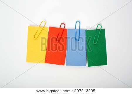 Multcolored labels with paper clips on a white background