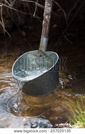 Clear water in a laddle from river