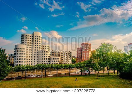 Looking at Media Harbor at Rhine-River in Dusseldorf in Germany. Media Harbor skyline among greenery of the city. Beautiful and colorful cityscape