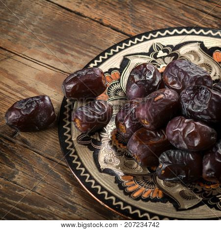 Fresh sweet dates on wooden background, close up