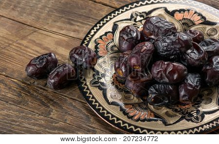 Fresh sweet dates on wooden background, close up