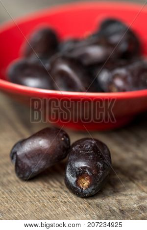 Fresh sweet dates on wooden background, close up