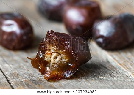 Fresh sweet dates on wooden background, close up