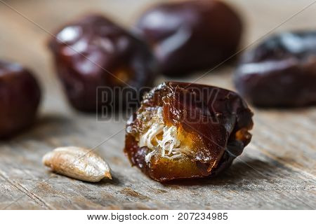 Fresh sweet dates on wooden background, close up