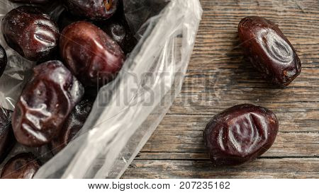 Fresh sweet dates on wooden background, close up