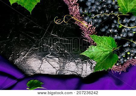 Red Wine Grapes In Voiolet Basket On Bllack Background. Top View. Copy Space.