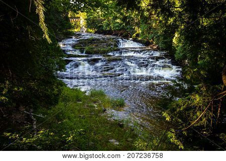Michigan Upper Peninsula Waterfall. Falls River Falls is an easily accessible waterfall located in the city of L Anse in Baraga County Michigan.