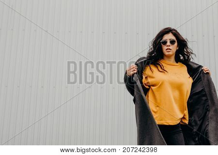 Portrait Of Stylish Modern Young Curly Woman In Coat Sunglasses. Soul In Out