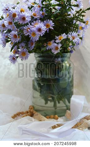 bouquet of delicate flowers in a vase on the window , good morning