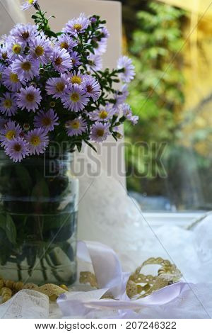 bouquet of autumn flowers in a vase on the window