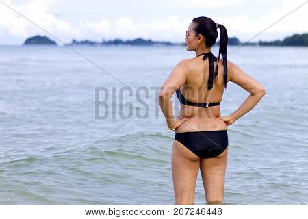 Woman with black bikini show beautiful on beach at Ban Krut Beach Prachuap Khirikhan Province Thailand
