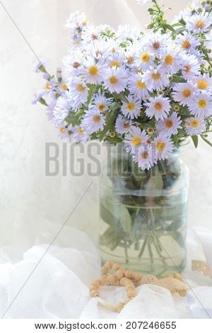 bouquet of delicate flowers in a vase on the window , good morning