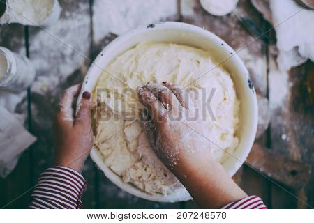 Close Up View Of Baker Kneading Dough. Homemade Bread. Hands Preparing Bread Dough On Wooden Table.