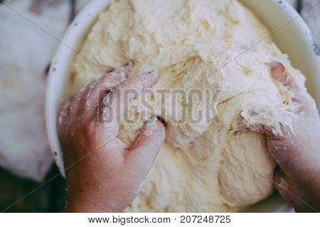 Close Up View Of Baker Kneading Dough. Homemade Bread. Hands Preparing Bread Dough On Wooden Table.