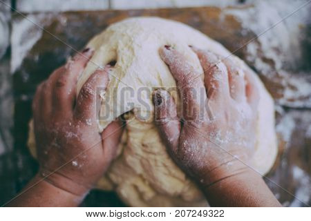 Close Up View Of Baker Kneading Dough. Homemade Bread. Hands Preparing Bread Dough On Wooden Table.