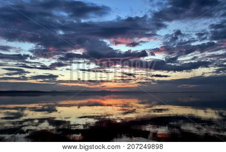 Colorful Sky Reflected In A Lake At Sunset