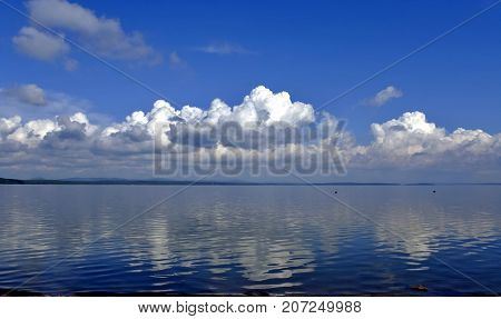 Bright Clouds Reflected In The Water