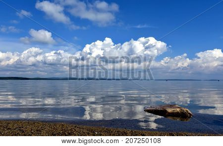 Bright Clouds Reflected In The Water