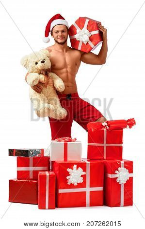 Beary Christmass. Handsome Santa Claus holding teddy bear and a present smiling cheerfully. 2018, 2019.