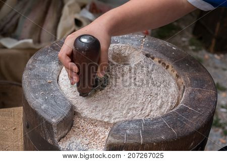Using an Ancient Manual Stone Mill by Little Boy