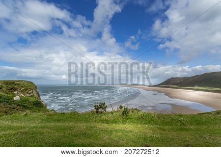 A landscape view of Rhossili Bay on the Gower Peninsula Swansea South Wales UK