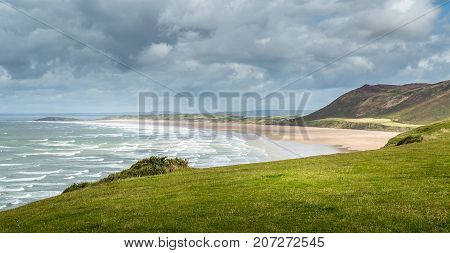 A landscape view of Rhossili Bay on the Gower Peninsula Swansea South Wales UK
