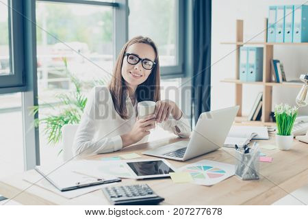 True Happiness. Successful Charming Relaxed Brown Haired Economist Is Enjoying Beverage At Her Work