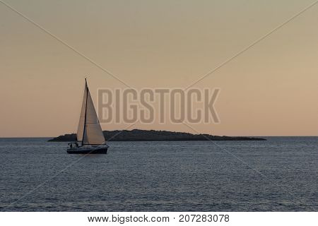 Sailing boat in the front of little rock island near Solta island Adriatic sea Croatia