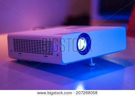 projector for presentation in a meeting room with laptop background