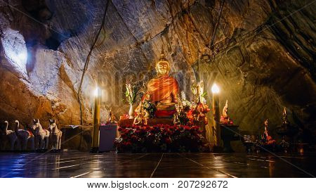 CHIANG RAI THAILAND - JULY 29 2017: Interior of Tham pha jom golden temple in the cave on July 29 2017 in Chiang rai Thailand.