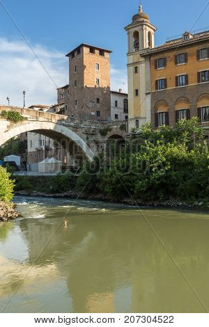 ROME, ITALY - JUNE 22, 2017: Amazing view of Castello Caetani, Tiber River and Pons Fabricius in city of Rome, Italy