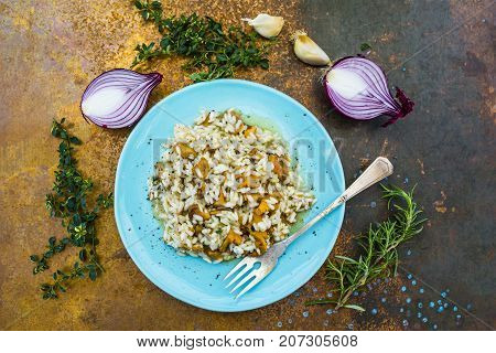 Risotto with chanterelle mushrooms and herbs. Italian food.