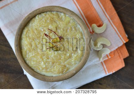 Vermicelli Kheer or pudding- an Indian sweet made with milk and fine noodles, served in an earthen bowl. View from top.