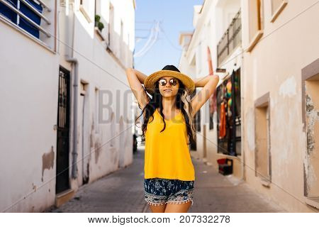 Happy smiling shine woman in hat and glasses,vacations traveler in europe,greece,santorini,turkey,eurotrip