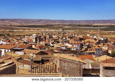an aerial view of the roofs of the old town of Caspe, in Spain, highlighting the bell tower of the Colegiata de Santa Maria la Mayor