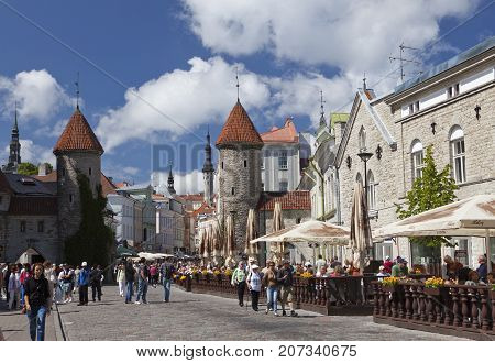 TALLINN ESTONIA- JUNE 18: tourists on the entrance from the Viru Gate of the Old city on June 18 2012 in Tallinn Estonia