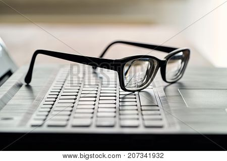 glasses on the computer keyboard during a break