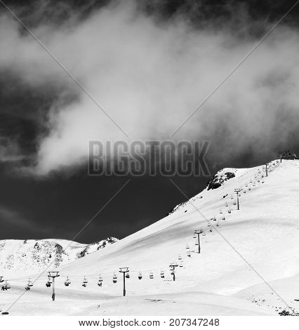 Black And White View On Chair-lift And Ski Slope In Sun Day